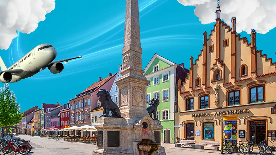 Ein Flugzeug fliegt über eine Stadt mit Gebäuden und einer Statue im Vordergrund.