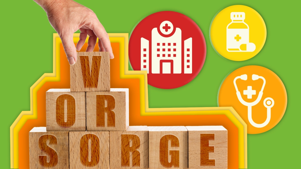 Eine Person legt Blöcke mit der Aufschrift "vor sorge" in einer kreativen Anordnung.